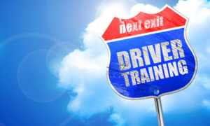 Driver Training road sign against blue sky